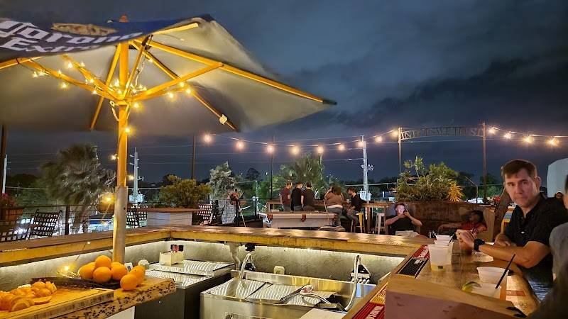 Rooftop seating at Hoptinger - Riverside at night